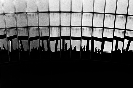 A reflection in a mirror at the Osaka Used Sky Building. 
From the photographic series "In Praise of Shadows". Shot on black and white film by photographer Matthew Fleming. 