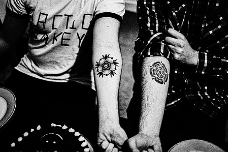 Photograph from the series To Live and Die in Lancashire: The Chapel of the Roses by Matthew James Fleming. Taken with a Leica M6 and Ilford HP5 35mm film. 
Two men display Lancashire Rose tattoos, Preston.