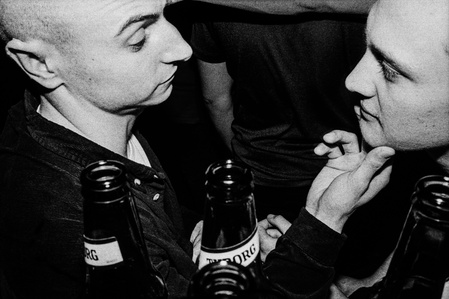 Two men, surrounded by beer bottles, share a touching moment at a rave, Manchester. 
Photograph from the series To Live and Die in Lancashire: Wet Paint by Matthew James Fleming. Taken with a Leica M6 and Ilford HP5 35mm film.