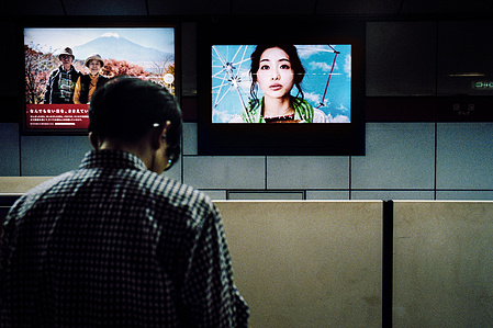 Advertising screens on the underground subway, Tokyo. 
Photograph from the series Forbidden Colours by Matthew James Fleming. Taken with a Leica M6 and Kodak Portra 800.