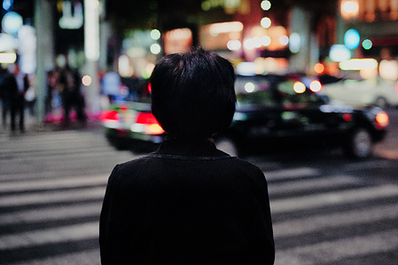 A woman waits at a pedestrian crossing, Ginza, Tokyo. 
Photograph from the series Forbidden Colours by Matthew James Fleming. Taken with a Leica M6 and Kodak Portra 800 35mm film.