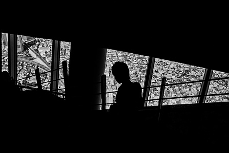 A figure descends the stairs in the Tokyo Skytree. 
From the photographic series "In Praise of Shadows". Shot on black and white film by photographer Matthew Fleming. 