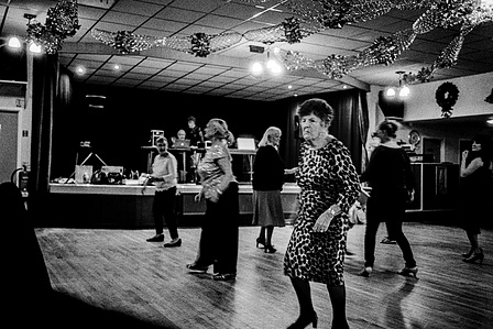 Photograph from the series To Live and Die in Lancashire: The Chapel of the Roses by Matthew James Fleming. Taken with a Leica M6 and Ilford HP5 35mm film. 
Women dance at an 80th birthday party. Poplar Social Club, Accrington.