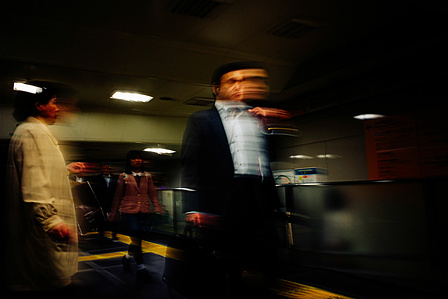 Commuters bustle through Skinjuku train station, Tokyo. 
Photograph from the series Forbidden Colours by Matthew James Fleming. Taken with a Leica M9.