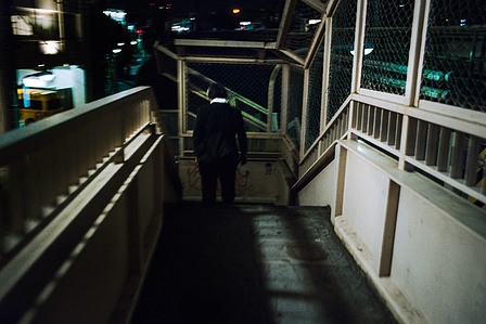 A suited man walks through a secluded area of Shinjuku, Tokyo. 
Photograph from the series Forbidden Colours by Matthew James Fleming. Taken with a Leica M6 and Kodak Portra 800.