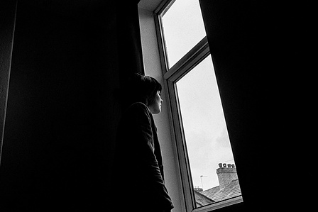 Photograph from the series To Live and Die in Lancashire: The Chapel of the Roses by Matthew James Fleming. Taken with a Leica M6 and Ilford HP5 35mm film. 
H gazes out the window our home, Preston.