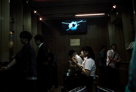 A busy smoking compartment in Akihabara, Tokyo. 
Photograph from the series Forbidden Colours by Matthew James Fleming. Taken with a Leica M6 and Kodak Portra 800.