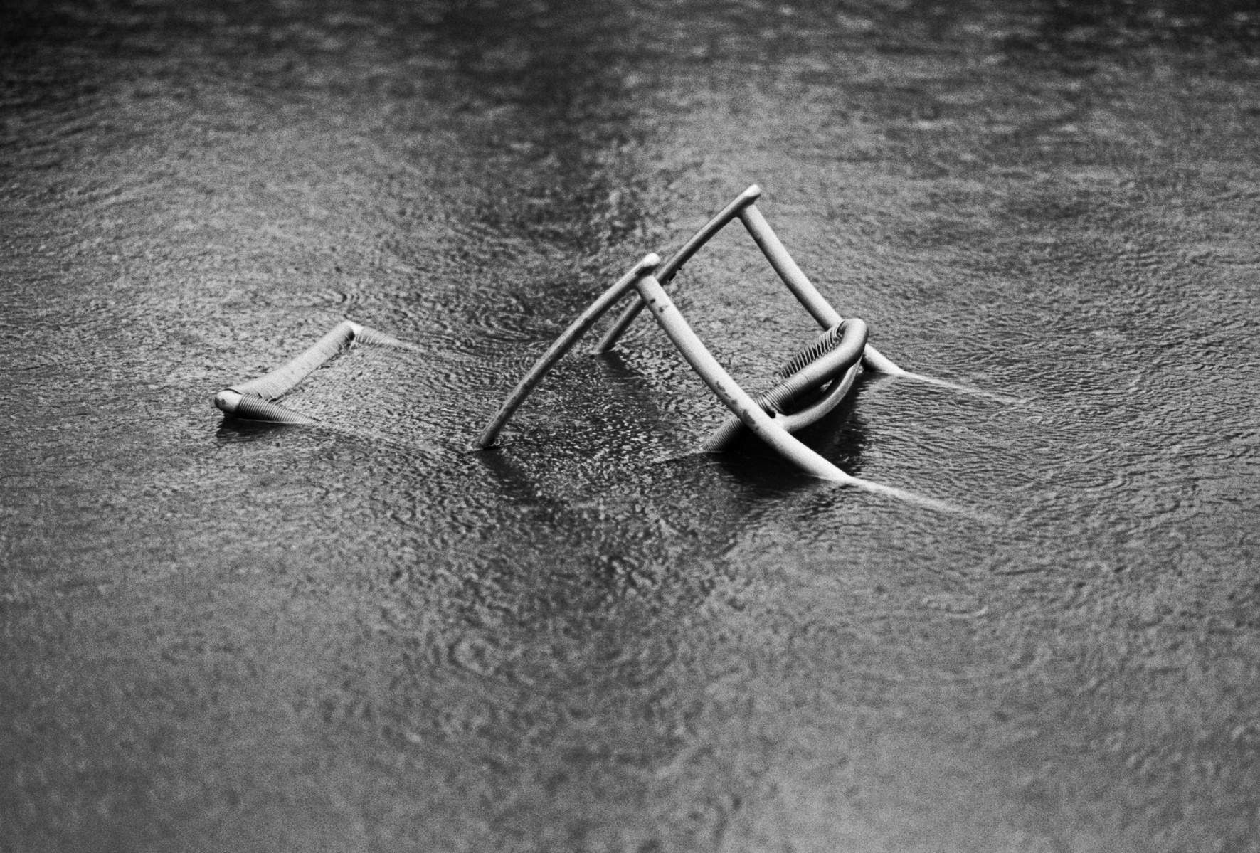 A garden chair is washed away during heavy flooding, Clitheroe, Lancashire, December 2015. Photographed by Matthew Fleming on 35mm Ilford HP5 film with a Leica M6.