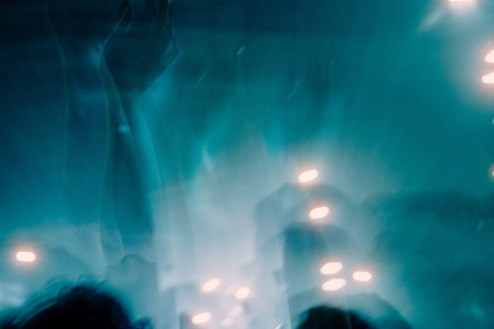 The raised arm of a reveller at the Warehouse Project Manchester, Aphex Twin Presents night. 
Photograph taken by Matthew Fleming with a Ricoh GR1v and Cinestill 800T 35mm film. 