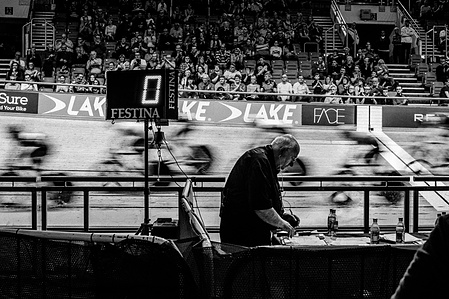 The lap counter announces the finish of a race at the Manchester Velodrome. Photo by Matthew Fleming, Lancashire.