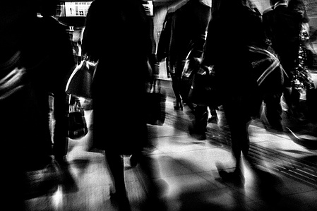 Commuters bustle towards the exist of Shinjuku train station, Tokyo. 
From the photographic series "In Praise of Shadows". Shot on black and white film by photographer Matthew Fleming. 