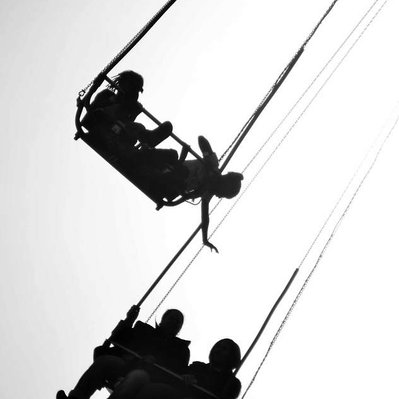 Black and white street photography of the french street photographer David Décamps representing a girl in a merry go round in Coney Island, New York City, USA.