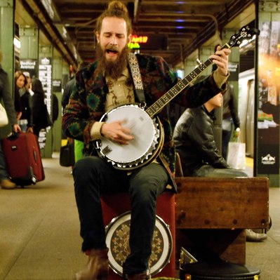 Street photography in colors of  the french street photographer David Décamps representing a musician playing in the subway in New York City, USA.