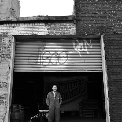 Black and white street photography of the french street photographer David Décamps representing a man standing in front his garage in Brooklyn, New York City, USA.