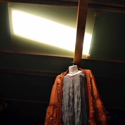 Street photography in colors of the french street photographer David Décamps representing a blue and orange dress in a store in New York City, USA.
