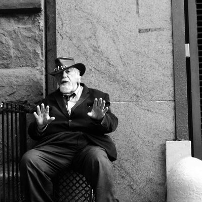 Black and white street photography of the french street photographer David Décamps representing a man surprise by the picture in New York City, USA.