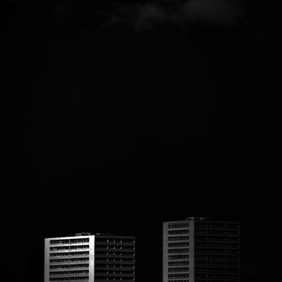 Black and white street photography of the french street photographer David Décamps representing two buildings in Paris.