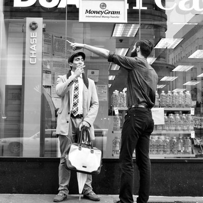 Black and white street photography of the french street photographer David Décamps representing two men talking in New York City, USA. 