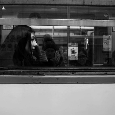 Black and white street photography of the french street photographer David Décamps representing a piece of a woman's face in the subway in Paris.