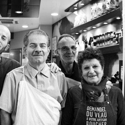 Black and white street photography of the french street photographer David Décamps representing the crew of butchers in front of their store in Paris.
