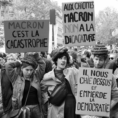 Black and white street photography of the french street photographer David Décamps representing four people during a strike in Paris.