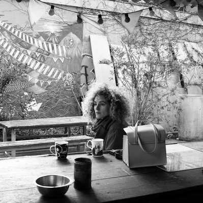 Black and white street photography of the french street photographer David Décamps representing a lost woman in a out bar in Paris.