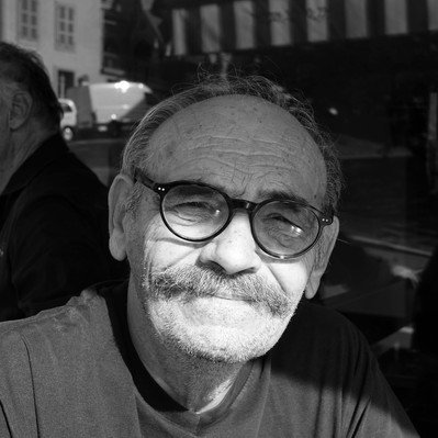 Black and white street photography of the french street photographer David Décamps representing a man with a nice moustache in Lausanne.