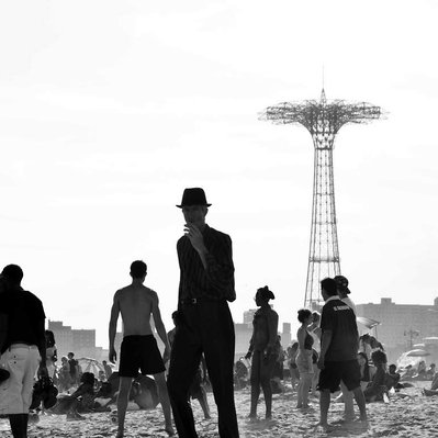 Black and white street photography of the french street photographer David Décamps representing the outline of a man with an intense look in Coney Island, New York City, USA.