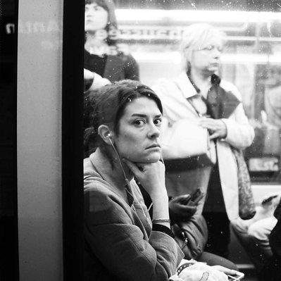 Black and white street photography of the french street photographer David Décamps representing a woman looking outside the subway in Paris.