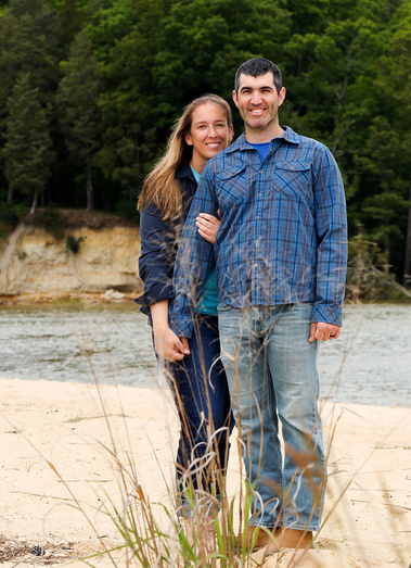 A couple stand together at the beach in Williamsburg, Virginia