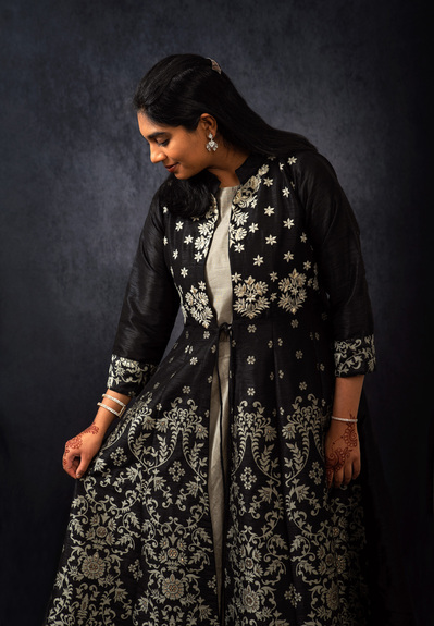 Low-key portrait of an Indian woman in a traditional black dress.  
Williamsburg, VA Photographer