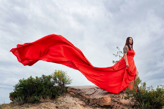 Woman in red dress outdoors in North Dakota by Williamsburg Portrait Photographer Dark Light Portrait Studios