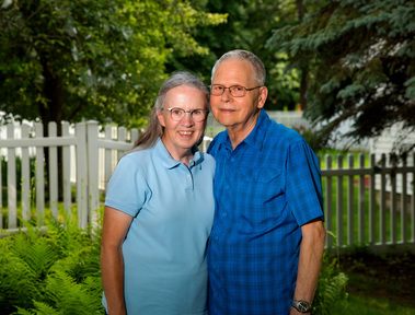 An older couple stand outside in Vermont