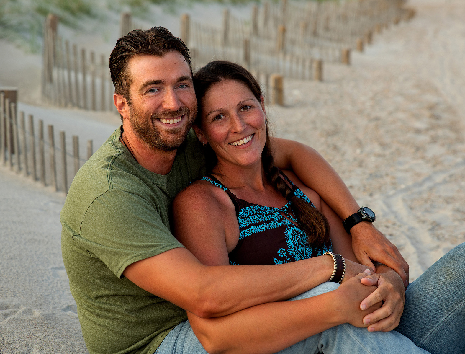A couple on vacation sits on the beach at Camp Lejeune in North Carolina