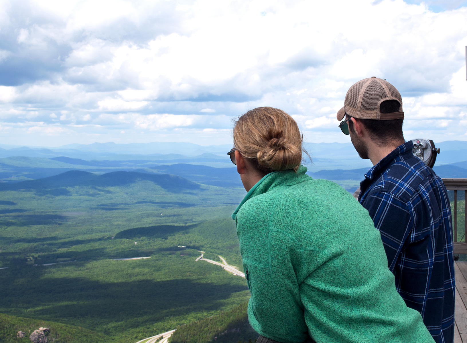 A young couple looks out over the mountain view at Canon Mountain, New Hampshire