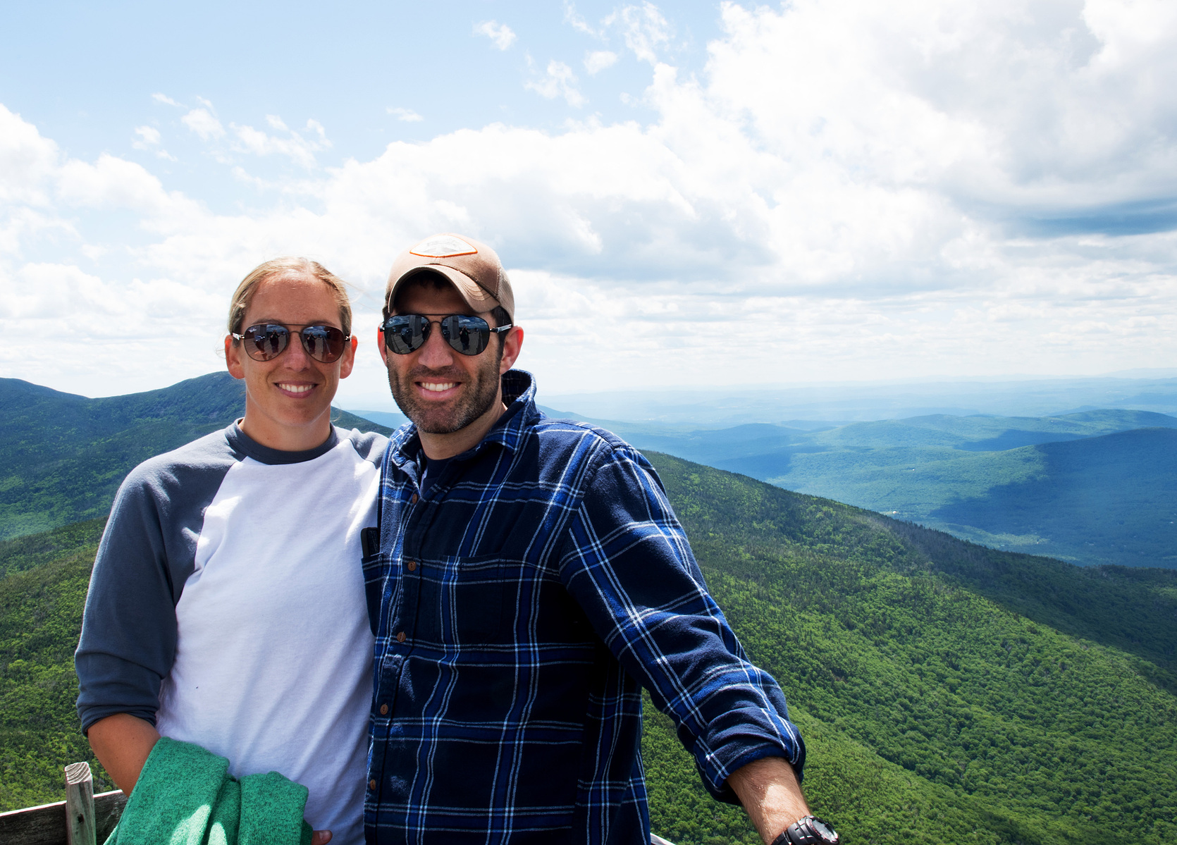 A young couple smiles for the camera while on vacation on Canon Mountain in New Hampshire