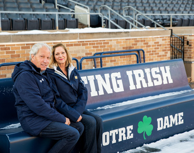 A married couple sit on a bench at the Notre Dame football stadium in Indiana