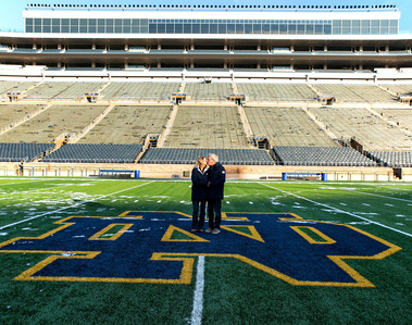 An older couple stand on the 50-yard line of the Notre Dame football field in Indiana