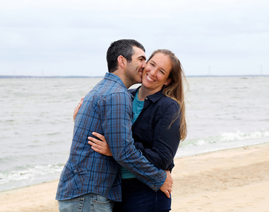A couple laugh and play around by the water in Williamsburg, VA