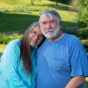 A married couple stand together outdoors in Vermont