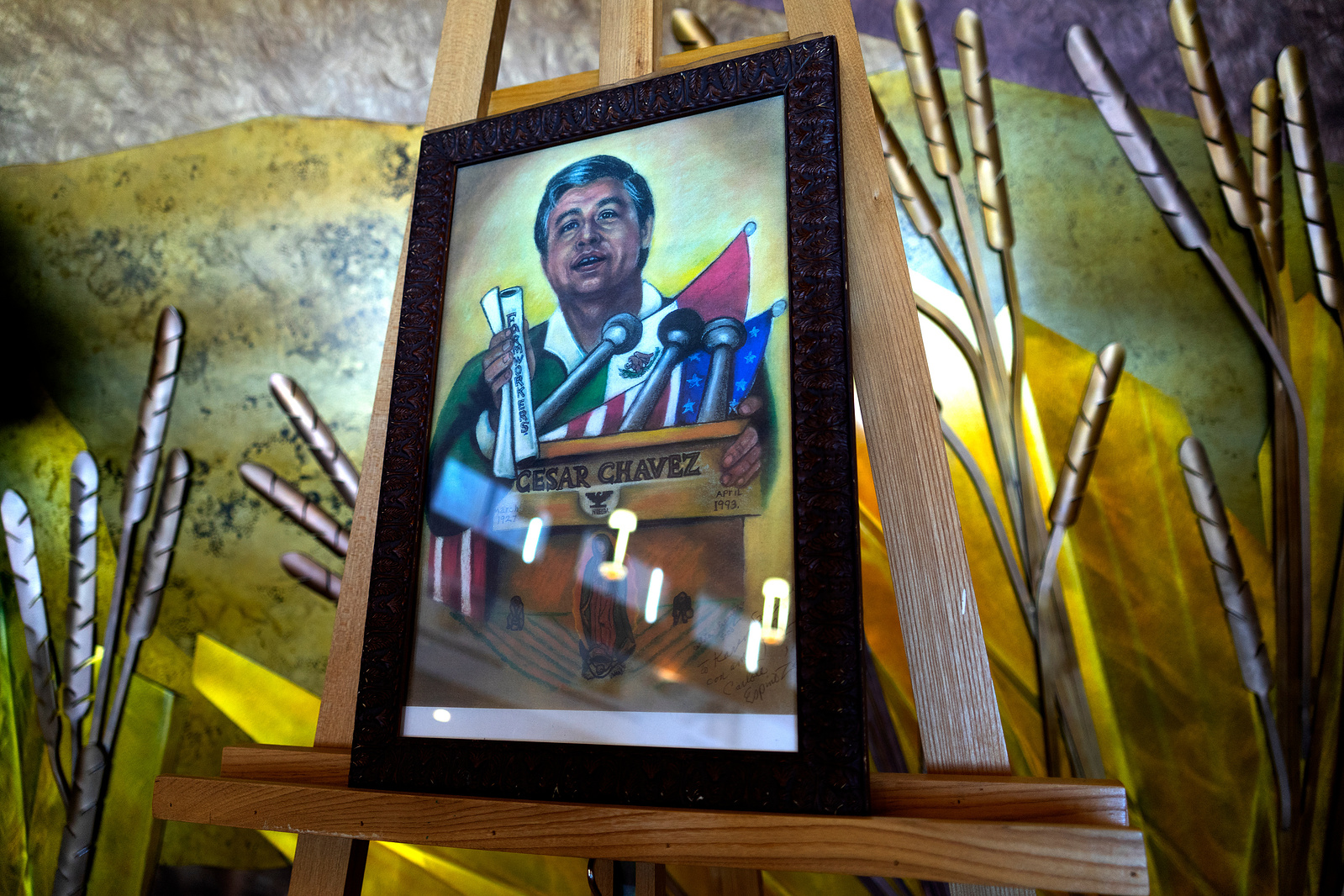 A painting of Cesar Chavez, beloved Chicano activist and labor union leader, sets behind the altar of St. John Francis Regis Chapel, Saturday, April 2, 2022, in Denver. Photo by Anthony Albidrez