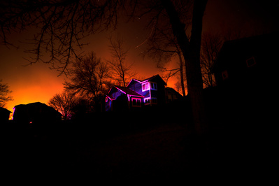The flames of the Marshall fire glow behind homes in a Louisville neighborhood during the early morning of Friday, December 31, 2021. . Photo by Anthony Albidrez
