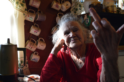 My grandmother Irma Lee Takala flips off the camera in her home on Kelly Street in Silver City, New Mexico on Saturday, January 10, 2015. As the afternoon sun beams through the window, Takala’s mug collection hangs on the wall behind her, and her rummage 