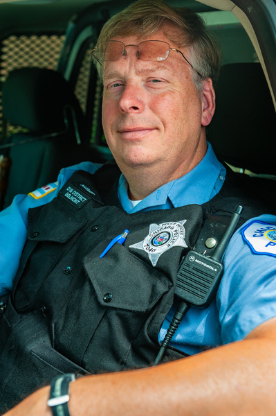 A friendly male Chicago police officer inside his squad car