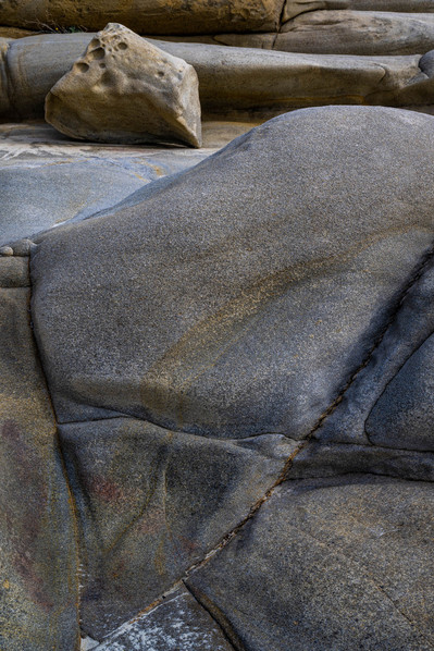 Close up perspective of boulders on a beach in Greece