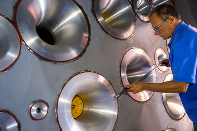 Technician inspecting parts at a production facility