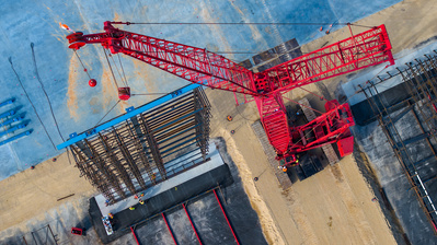 Aerial photographer view of a tall crane transporting a shelving component at KraftHeinz distribution facility in DeKalb, IL