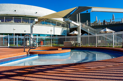 Hot tub and main building of the Midtown Athletic Club in Forest Grove, IL in morning light