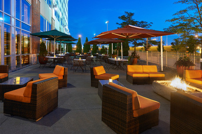 Commercial photography of an outdoor seating area of a DoubleTree by Hilton hotel at dusk 