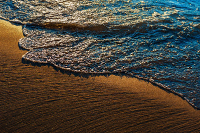 Wave arriving at a beach at dusk at Lake Michigan
